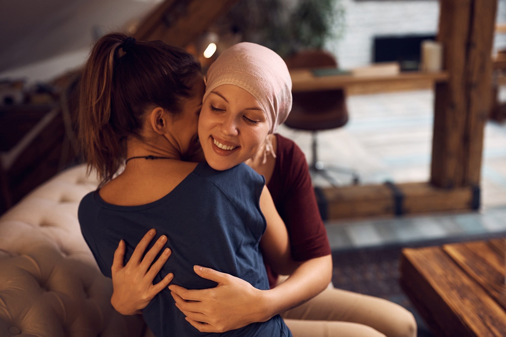 Two women hugging. Caring for a breast cancer patient takes more than logistics. Here's how to support your loved one physically, emotionally, and practically.