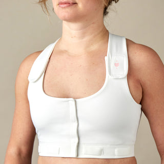 Front view of white Larissa Post-Surgical Bra for recovery with drain management, showing adjustable straps and front closure, tabs to manage drainage bulbs and wide flat band that won't roll or twist.