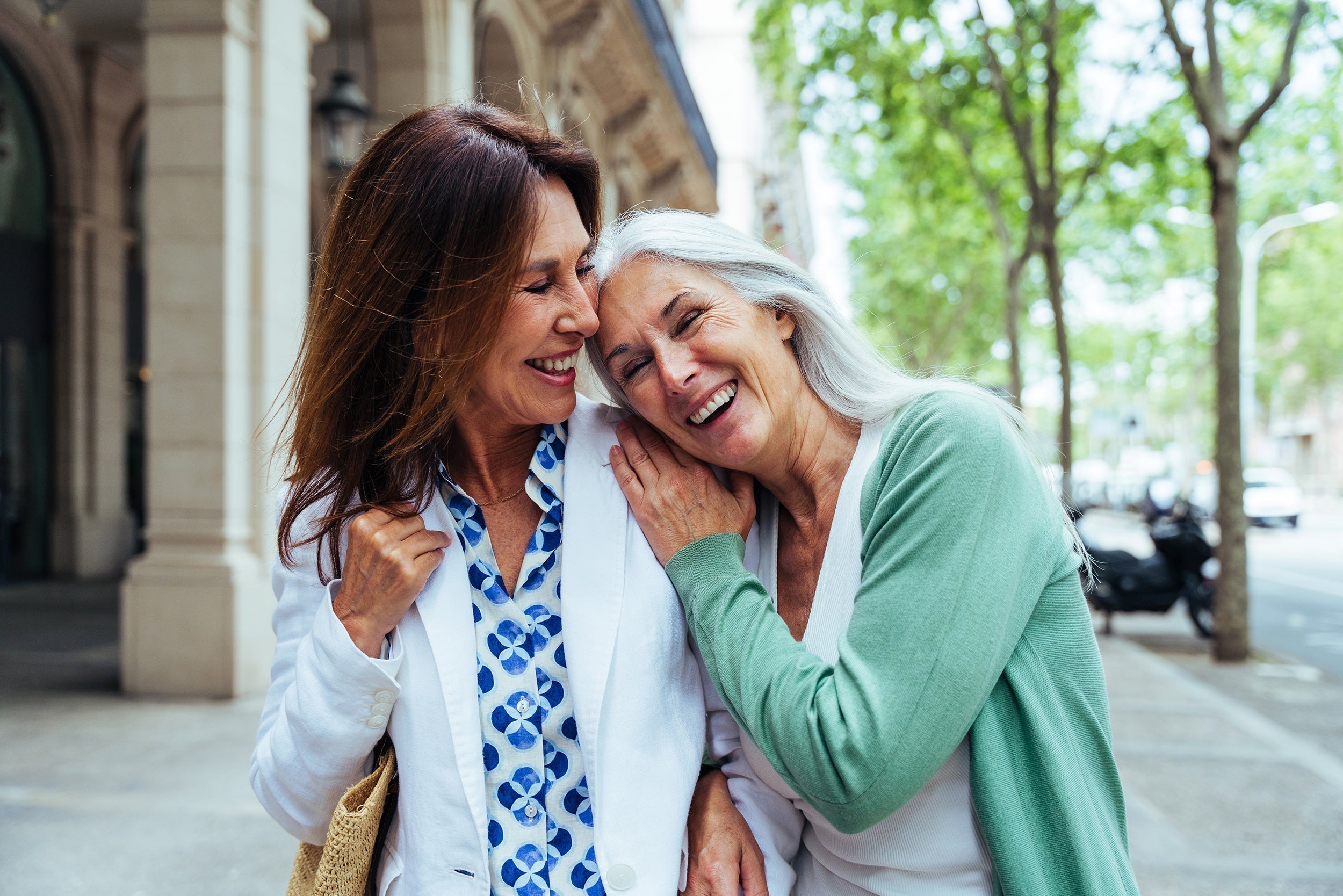 Two women walking together. Compression bra timelines after mastectomy vary by surgery type. Here's what to expect—and how to prepare before surgery day.