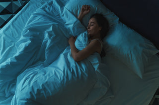 A woman sleeps in bed. Learn when you can safely sleep without a bra after breast reduction. Expert recovery timelines, healing phases, readiness signs, and post-surgical bra guidance.